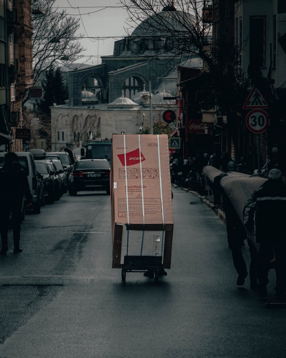 red and white box on road during daytime